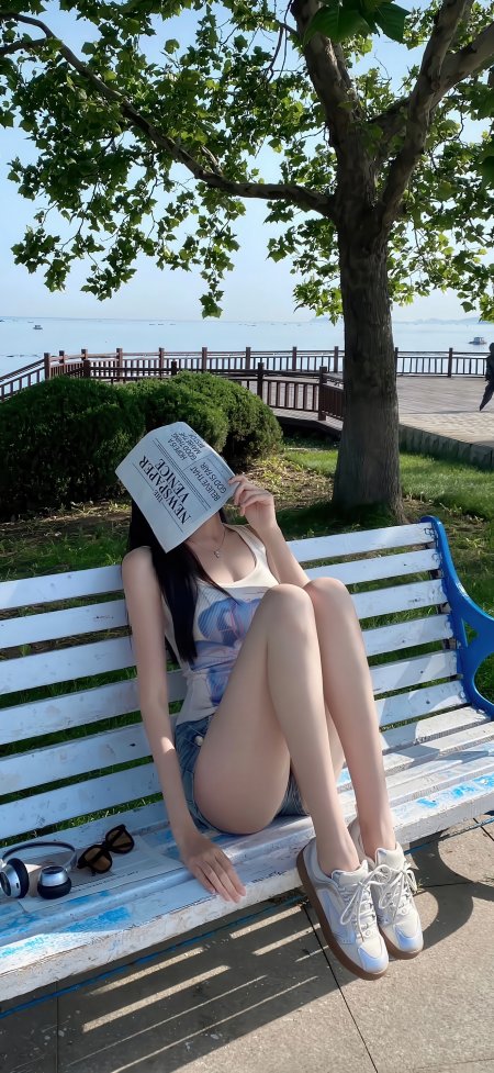 海边树荫下少女持报纸遮脸坐长椅手机壁纸