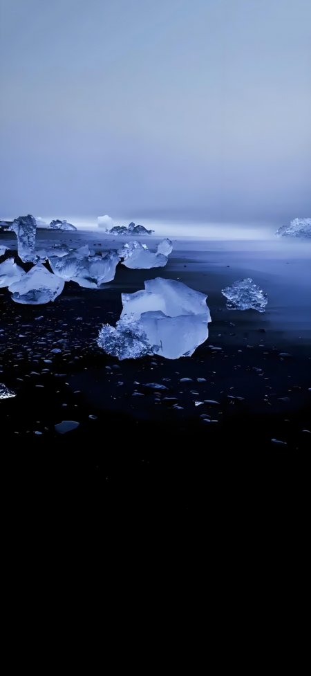 冰块散落黑沙滩海边风景手机壁纸