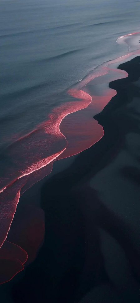 航拍红色海浪蜿蜒黑色沙滩抽象风景手机壁纸