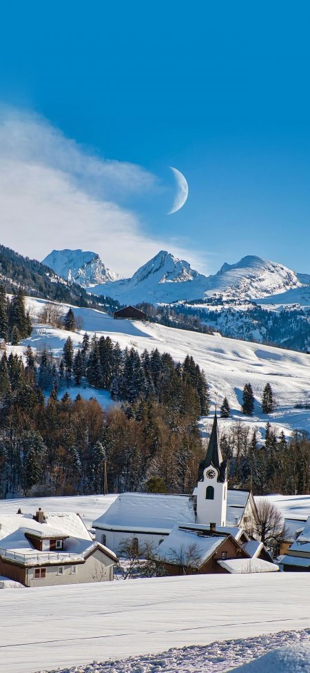 瑞士雪山教堂月挂蓝天静谧冬日风光风景手机壁纸