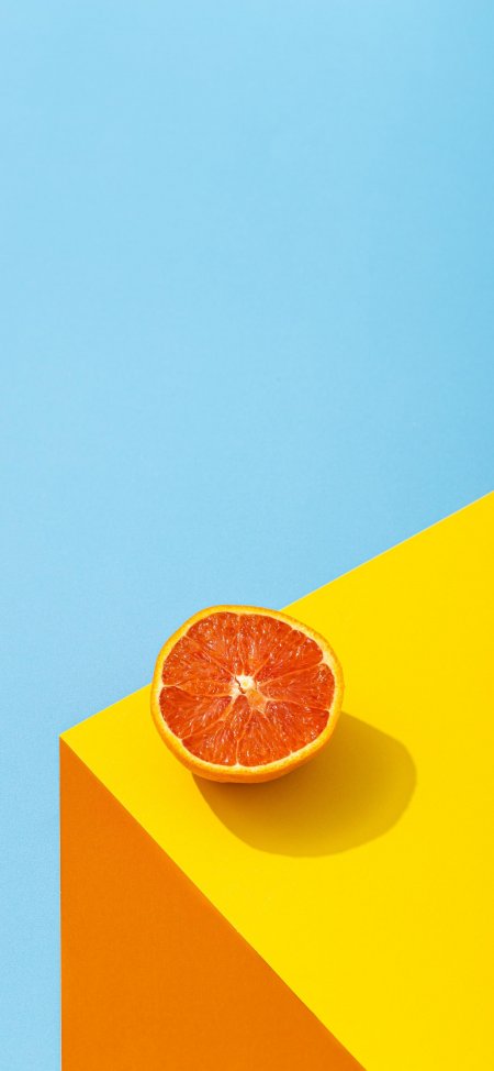 橙子切片置于黄橙几何色块清新水果静物手机壁纸