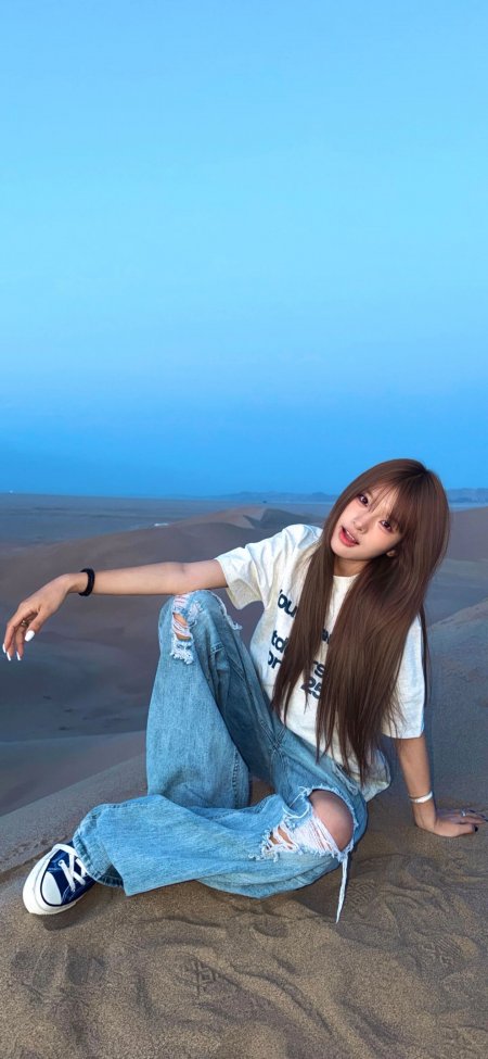 美女沙漠坐姿休闲穿搭蓝天背景时尚旅拍人物摄影手机壁纸