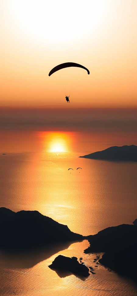 滑翔伞剪影金色海岸日落海面冒险风景手机壁纸