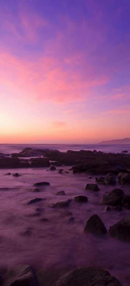 粉紫长曝光海岸岩石治愈风景手机壁纸