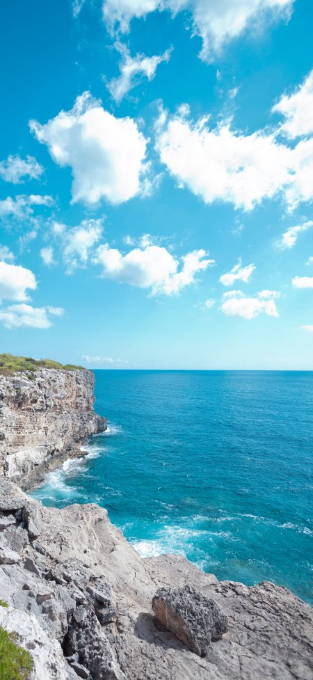 悬崖峭壁蔚蓝海天白云风景手机壁纸