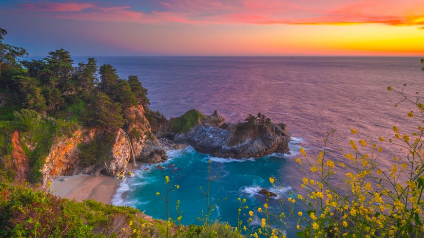 日落海湾悬崖瀑布碧蓝海水鲜花风景电脑壁纸