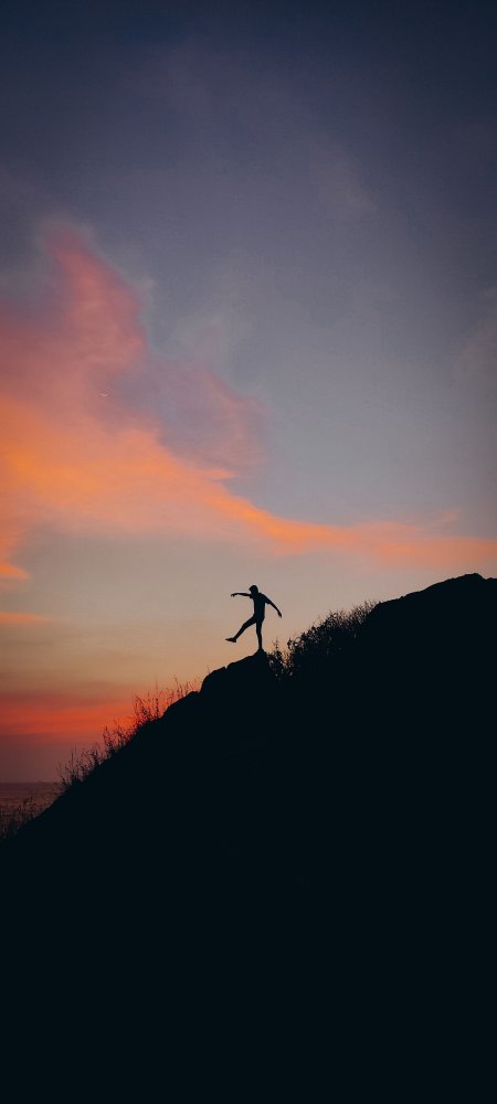 剪影人物山巅单脚平衡橙紫渐变风景手机壁纸