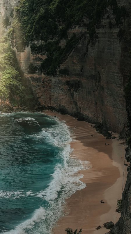悬崖海滩碧浪拍岸棕褐风景手机壁纸