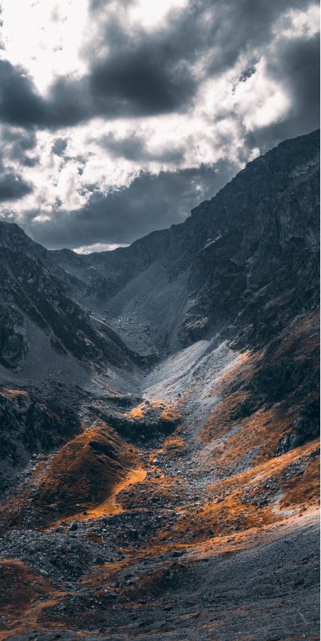 高山峡谷光影交错灰橙风景手机壁纸