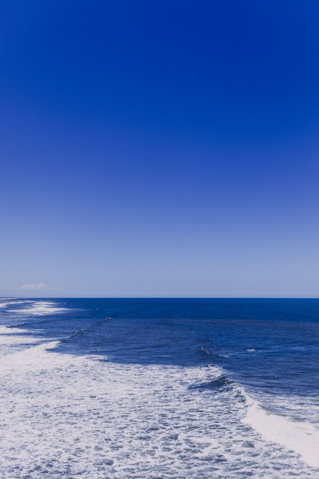 蔚蓝海天交界白浪翻涌蓝白风景手机壁纸