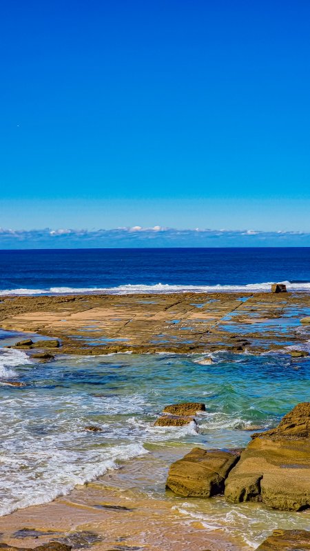 海岸礁石浪花碧蓝自然风景手机壁纸