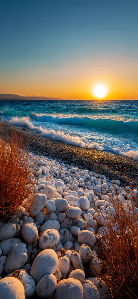 夕阳海浪白石滩金橙蓝调自然风景手机壁纸