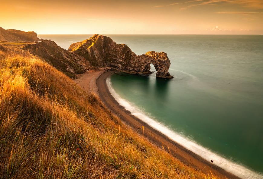 英国多塞特郡杜德尔门天然拱门海岸日落金橙碧海风景电脑壁纸
