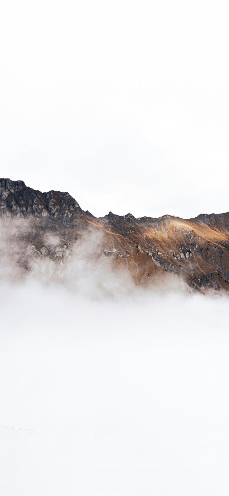 雪山云海缭绕岩壁棕灰白自然风景手机壁纸