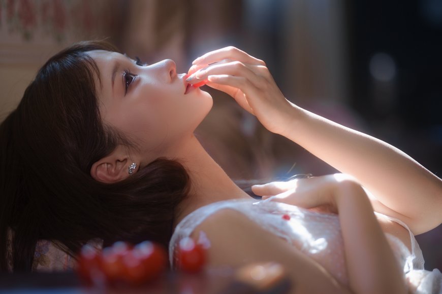 黑发少女仰卧轻衔红果暖光人物摄影电脑壁纸