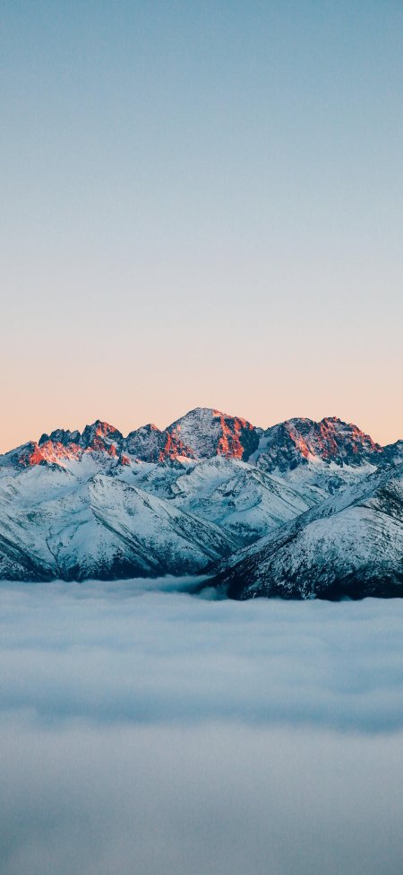 雪山巍峨云海缭绕晨曦金边蓝白风景手机壁纸
